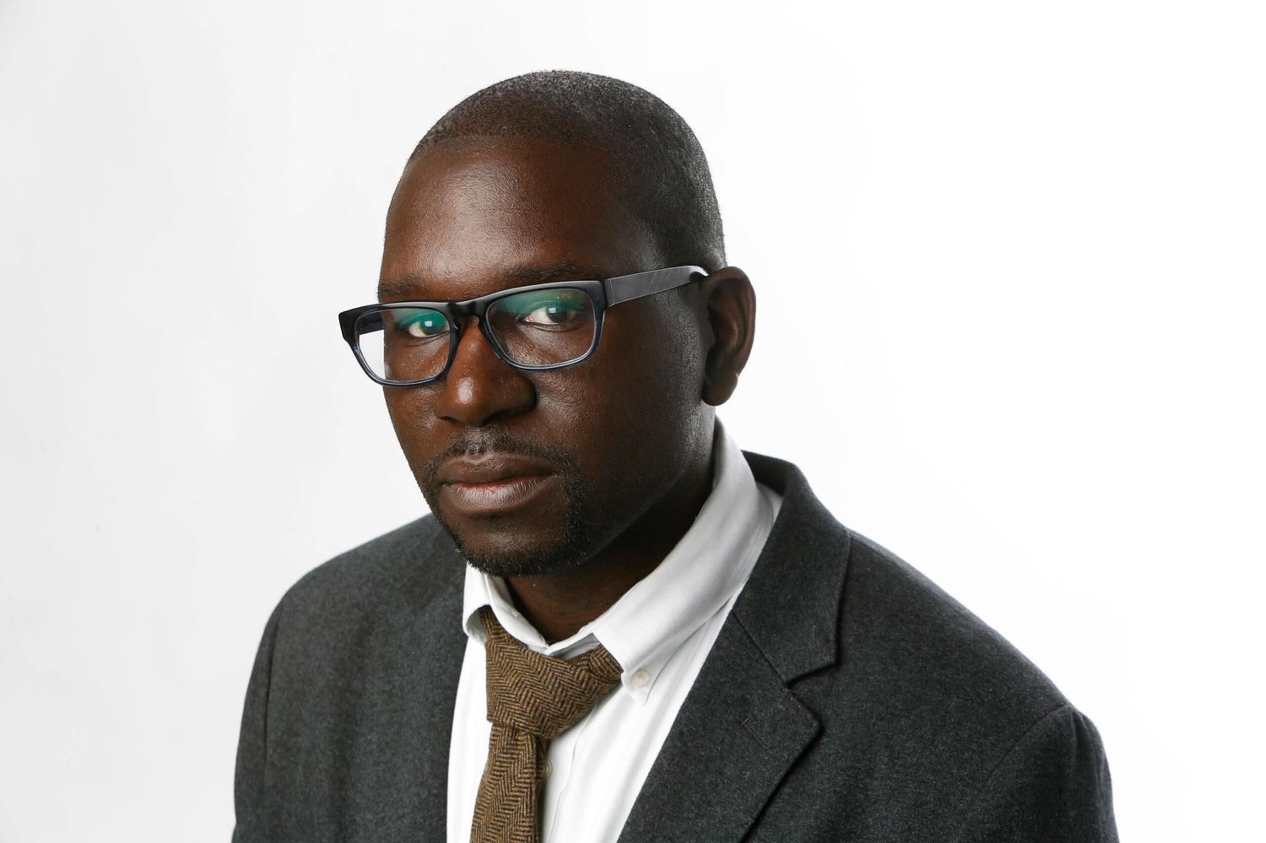 headshot of Bouie in gray coat and brown tie